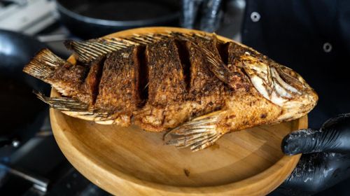 Whole grilled tilapia with West African marinade at Birdies & Brewz Karen